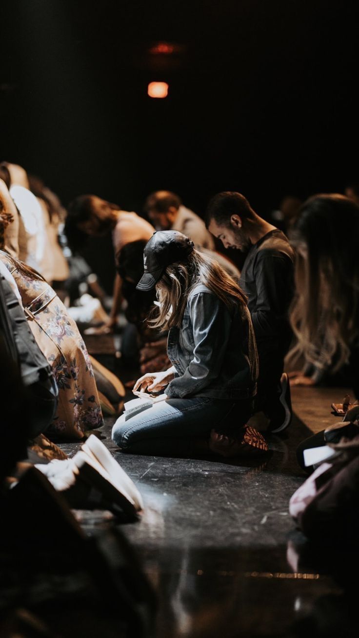 Church members kneeling in quiet prayer during a service